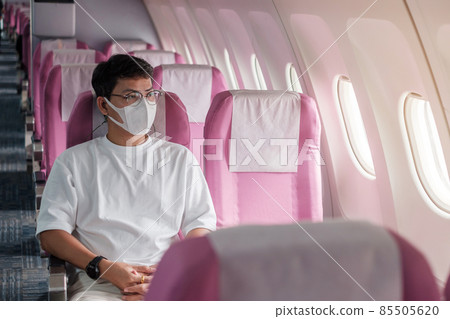 man wearing protective face mask in airplane or public transportation, protection Coronavirus disease infection, Asian tourist ready to travel. Next Normal and reopening concept 85505620
