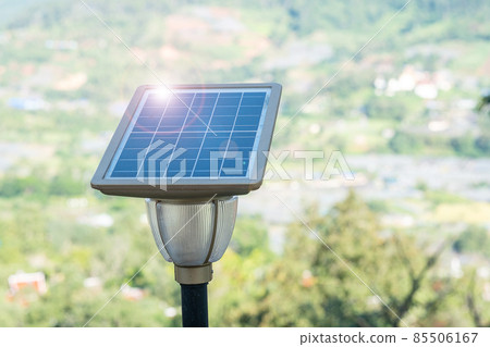 Small Solar photovoltaic panels with light lamp in forest, electrical power generation systems. alternative, renewable energy and sustainable resources concept 85506167