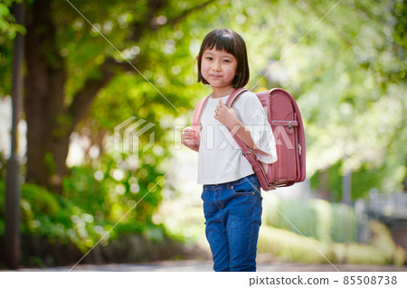 Girls carrying a school bag Girls carrying a school bag 85508738