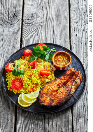 oven baked salmon steak with yellow rice 85509063