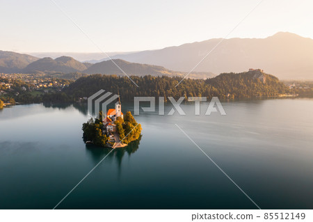 Island with church on it with Slovenian Julian apls in background 85512149