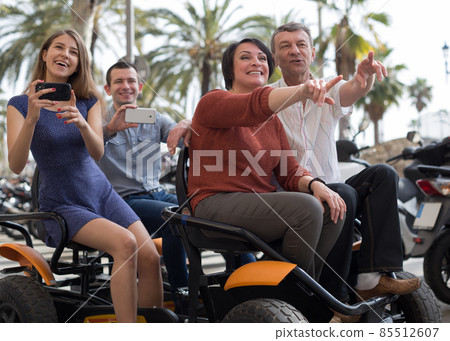 family of tourists enjoy a walk on the bike carriage family of tourists enjoy a walk on the bike carriage 85512607
