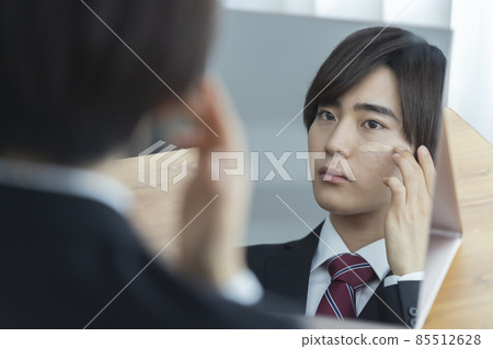 年輕男子在西裝應用奶油粉底男士化妝的形象 年輕男子在西裝應用奶油粉底男士化妝的形象 85512628