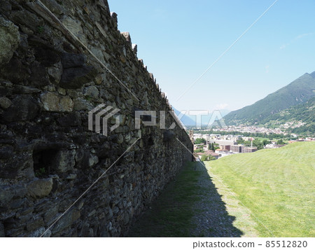 Castle wall and alpine landscape in Bellinzona city in Switzerland Castle wall and alpine landscape in Bellinzona city in Switzerland 85512820