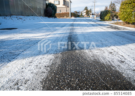 Road sprinkled with calcium chloride on a snowy day Road sprinkled with calcium chloride on a snowy day 85514085