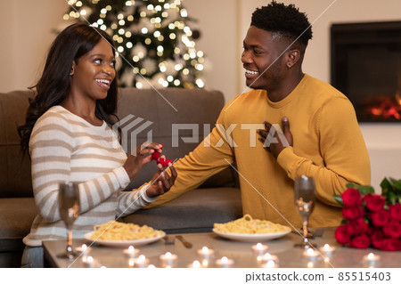 African Woman Proposing To Man Showing Engagement Ring Box Indoor African Woman Proposing To Man Showing Engagement Ring Box Indoor 85515403