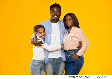 Happy black guy posing with wife and smiling teen daughter Happy black guy posing with wife and smiling teen daughter 85515418