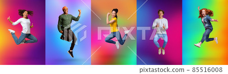 Expressing joy and happiness. Full length of energetic diverse young people jumping over colorful neon backgrounds 85516008