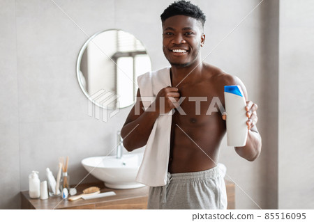 Black Guy Holding Shampoo Bottle Advertising Male Product In Bathroom Black Guy Holding Shampoo Bottle Advertising Male Product In Bathroom 85516095