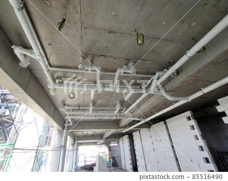 PENANG, MALAYSIA -JANUARY 5, 2021: Sewerage pipes from the toilet above are interconnected under the floor soffit. Installed in gradient and gravity flow. Channeled to the main sewer line.  85516490