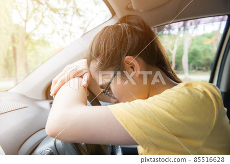 Portrait of tired or drunk woman sleeping in the car lying at steering wheel. Conceptual of people lifestyle/healthy. Portrait of tired or drunk woman sleeping in the car lying at steering wheel. Conceptual of people lifestyle/healthy. 85516628