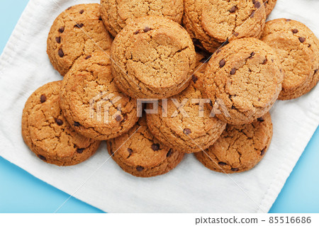 Oatmeal cookies on a blue background and a white napkin top view 85516686