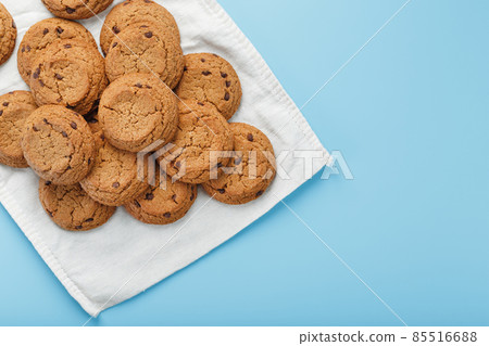 Oatmeal cookies on a blue background and a white napkin top view Oatmeal cookies on a blue background and a white napkin top view 85516688