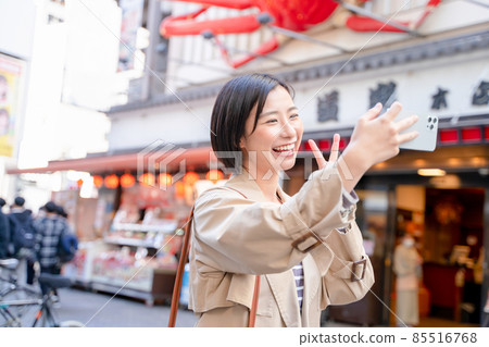 A woman enjoying sightseeing in Osaka A woman enjoying sightseeing in Osaka 85516768