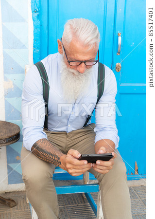 Senior man with a phone 85517401
