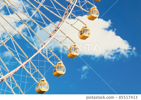 Ferris wheel floating in blue sky 85517413