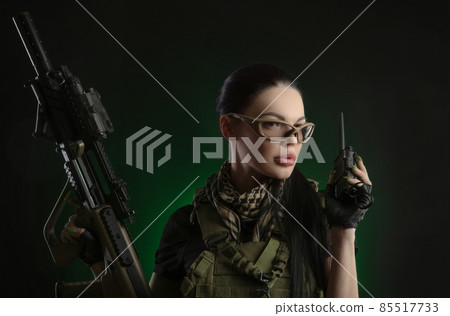 the girl in military special clothes posing with a gun in his hands on a dark background in the haze the girl in military special clothes posing with a gun in his hands on a dark background in the haze 85517733