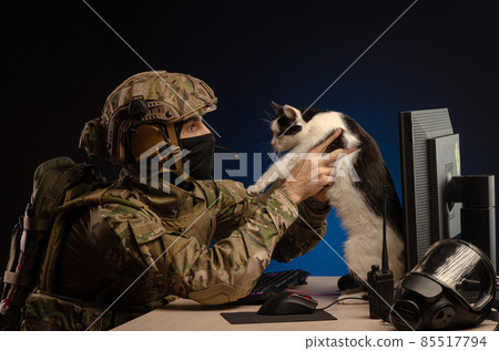 soldier sitting at a computer is conducting a cyber war soldier sitting at a computer is conducting a cyber war 85517794
