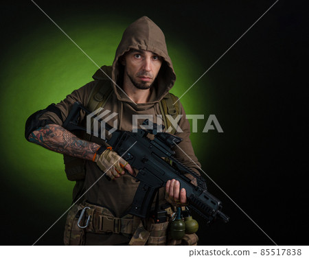 man Stalker with a gun with an optical sight and a backpack on a dark background with emotions looking, aiming, watching, sneaking man Stalker with a gun with an optical sight and a backpack on a dark background with emotions looking, aiming, watching, sneaking 85517838