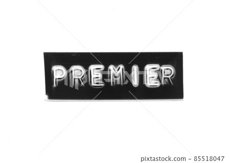 Black color banner that have embossed letter with word premier on white paper background 85518047
