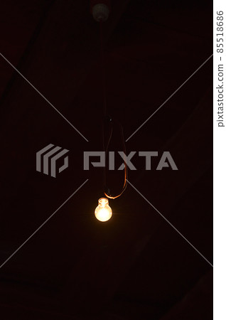 Bare light bulb. Light bulb on black background. The image of the lamp. 85518686