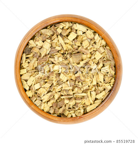 Liquorice root chips, in a wooden bowl. Dried, cut root of licorice, Glycyrrhiza glabra. Used as tea, or as sweet extract for flavouring candies, sweets and tobacco. Also used in traditional medicine Liquorice root chips, in a wooden bowl. Dried, cut root of licorice, Glycyrrhiza glabra. Used as tea, or as sweet extract for flavouring candies, sweets and tobacco. Also used in traditional medicine 85519728