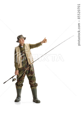 Portrait of young man, professional fisherman with fishing rod, spinning and equipment going to river isolated over white studio background Portrait of young man, professional fisherman with fishing rod, spinning and equipment going to river isolated over white studio background 85520701