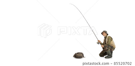Portrait of young man, professional fisherman with fishing rod, spinning and equipment going to river isolated over white studio background Portrait of young man, professional fisherman with fishing rod, spinning and equipment going to river isolated over white studio background 85520702