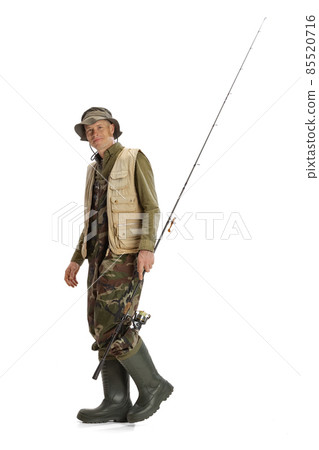 Portrait of young man, professional fishman with fishing rod, spinning and equipment going to river isolated over white studio background Portrait of young man, professional fishman with fishing rod, spinning and equipment going to river isolated over white studio background 85520716