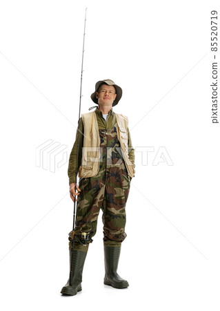 Portrait of young man, professional fisherman with fishing rod, spinning and equipment going to river isolated over white studio background Portrait of young man, professional fisherman with fishing rod, spinning and equipment going to river isolated over white studio background 85520719