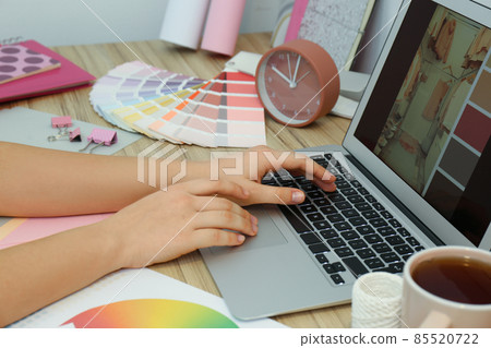Female designer working at wooden table indoors, closeup Female designer working at wooden table indoors, closeup 85520722
