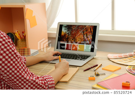 Female designer working at wooden table indoors, closeup Female designer working at wooden table indoors, closeup 85520724