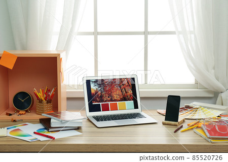 Designer's workplace with modern laptop and color palettes Designer's workplace with modern laptop and color palettes 85520726
