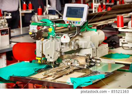 Modern sewing equipment in a sewing factory, a sewing machine with programmable functions close-up. Modern sewing equipment in a sewing factory, a sewing machine with programmable functions close-up. 85521163