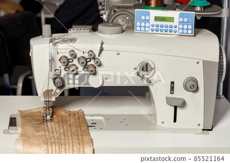 Professional programmable sewing machine for hemming and sewing clothes. Close-up. Professional programmable sewing machine for hemming and sewing clothes. Close-up. 85521164