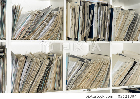 Shelves are full with folders and files of medical record, patient information Shelves are full with folders and files of medical record, patient information 85521394
