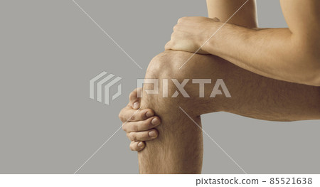 Narrow crop shot of man touch kneecap suffer from acute ache. Pain in knee. Unhealthy sick male struggle with inflammation in leg. Arthritis or osteoarthritis. Healthcare and medicine concept. 85521638