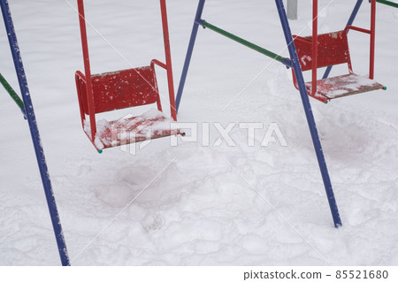Swing seat covered with snow, winter season 85521680
