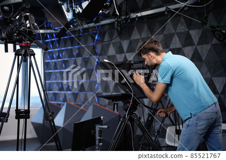 Professional video camera operator working in studio Professional video camera operator working in studio 85521767