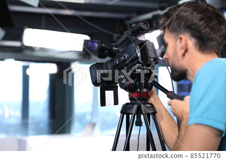 Professional video camera operator working in studio, closeup Professional video camera operator working in studio, closeup 85521770