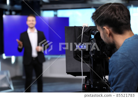 Professional video camera operator working in studio, closeup Professional video camera operator working in studio, closeup 85521783