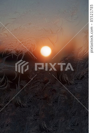 Frosty pattern on glass at sunset winter background 85521785