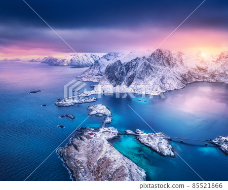 Aerial view of snowy mountains in low clouds, islands and rocks 85521866
