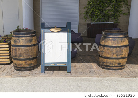 bulletin board for menus and advertisements and wooden barrels 85521929