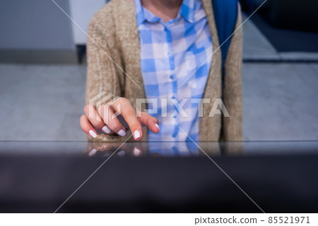Woman using interactive touchscreen display at modern museum or exhibition 85521971