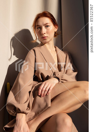Young white european woman with curtains behind Young white european woman with curtains behind 85522367