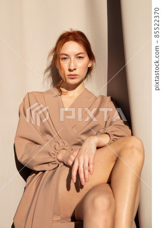 Young white european woman with curtains behind Young white european woman with curtains behind 85522370