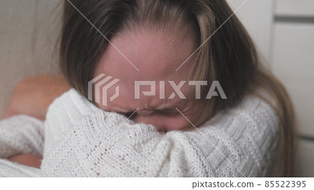 A teenage child cries and tears run down her cheeks. The girl is upset due to hormonal changes in the body. Children's nervousness from problems with peers and parents. Lifestyle soul cry. Fear and 85522395