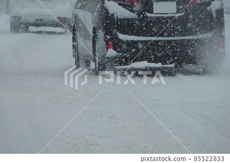 Snow scene: A car running on a snowy road 85522833