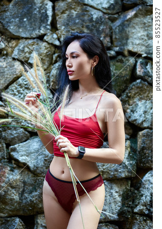 Young asian model posing in front of stone wall 85523527